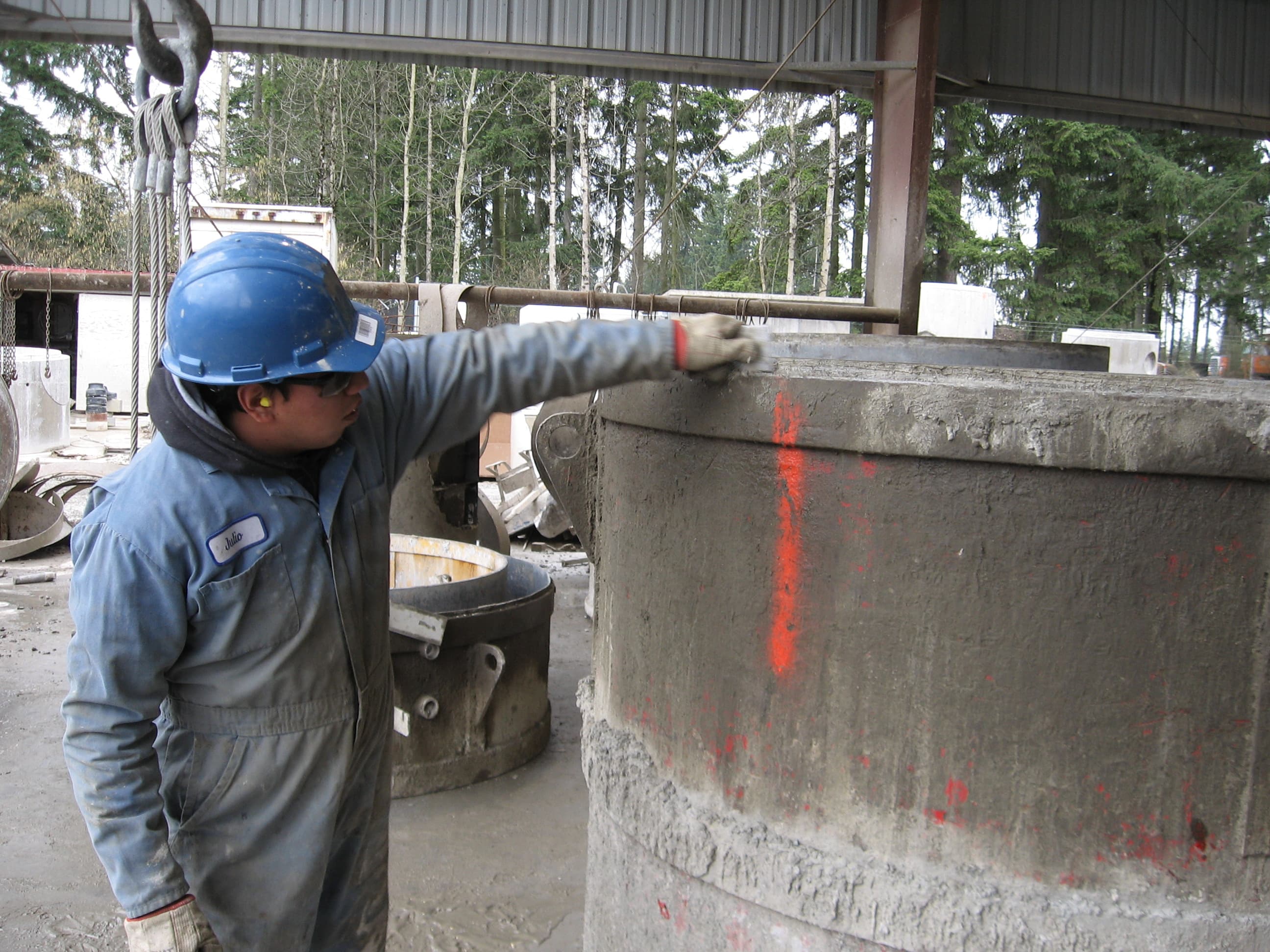 Worker inspecting a precast concrete product