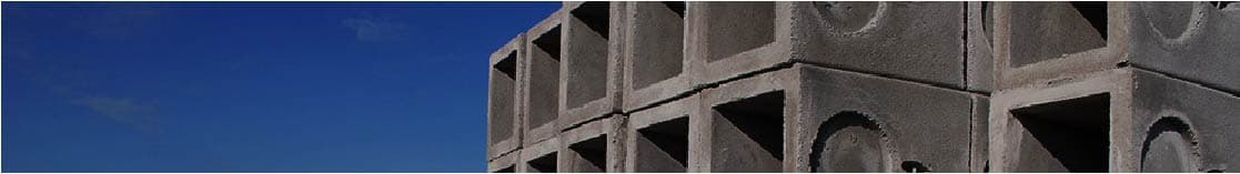 Stacked precast concrete vaults under blue sky