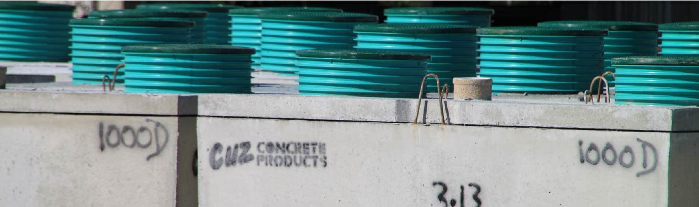 Cuz Concrete Products in the yard with company branding