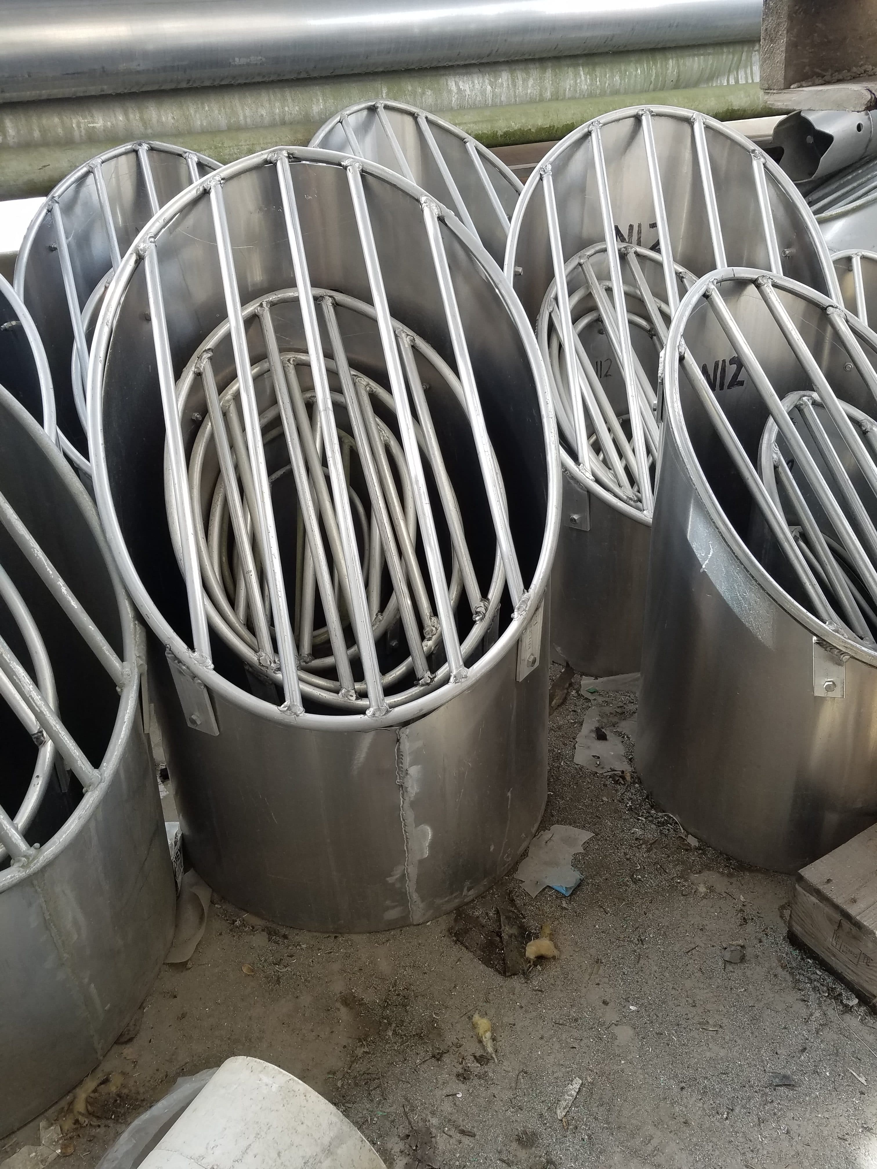 Cylindrical metal frames and tubes stacked outdoors